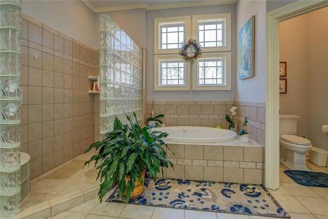 full bathroom featuring tile patterned flooring, a garden tub, toilet, crown molding, and a walk in shower