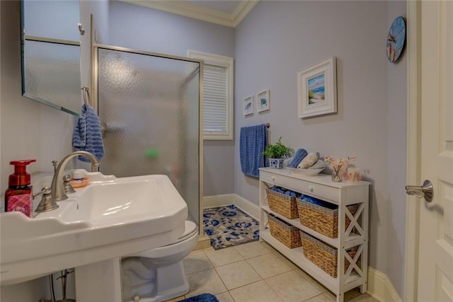 full bathroom with ornamental molding, a shower stall, tile patterned floors, a sink, and baseboards