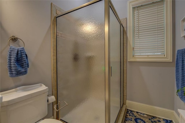 full bath with a stall shower and toilet