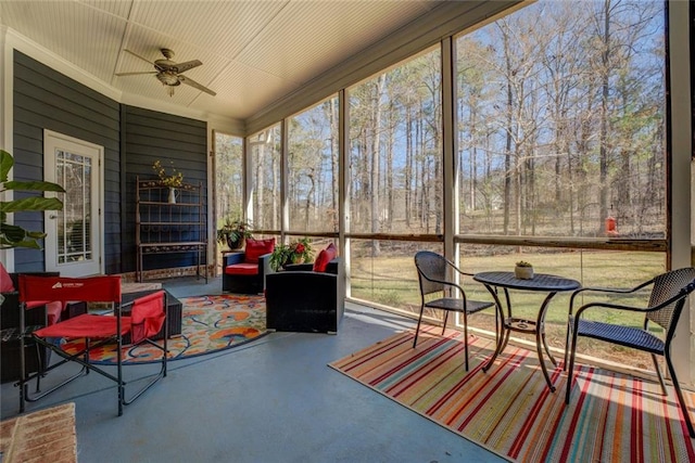 sunroom with ceiling fan and an outdoor hangout area