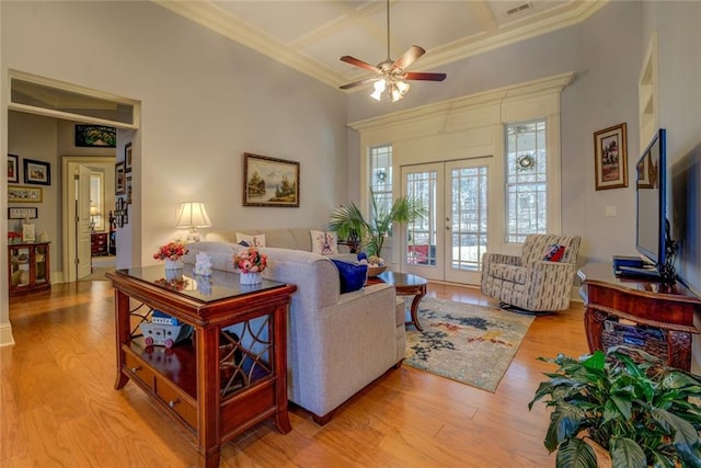 living room featuring french doors, wood finished floors, ceiling fan, coffered ceiling, and ornamental molding