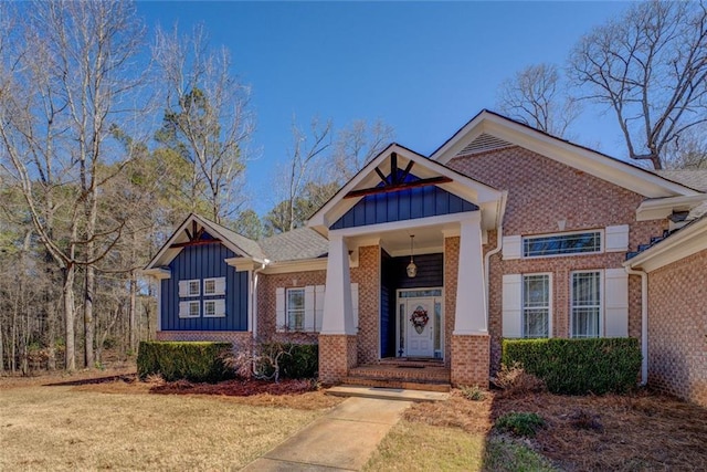 craftsman-style house with board and batten siding and brick siding