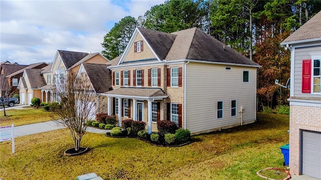 view of front of property with a front yard and a garage