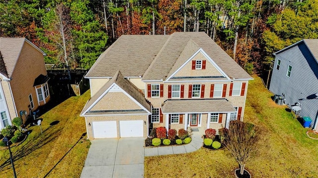 view of front of property featuring a garage and a front yard