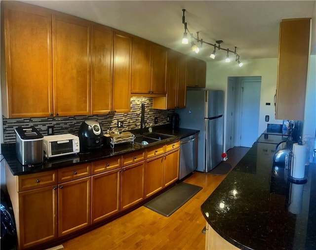 750 Dalrymple Rd Unit G3, Atlanta, GA 30328 - kitchen with stainless steel appliances, light wood-type flooring, tasteful backsplash, and dark stone counters