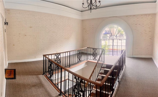 750 Dalrymple Rd Unit G3, Atlanta, GA 30328 - stairs with brick wall, carpet flooring, baseboards, and a chandelier
