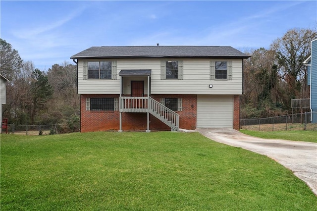 raised ranch with a front yard and a garage