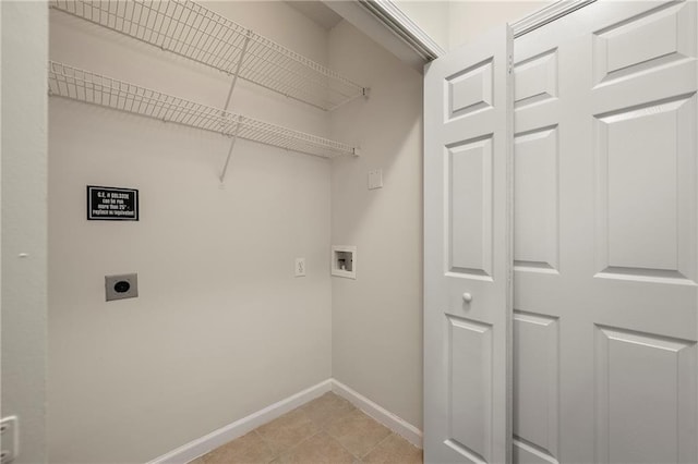 laundry area featuring light tile patterned floors, hookup for a washing machine, and hookup for an electric dryer