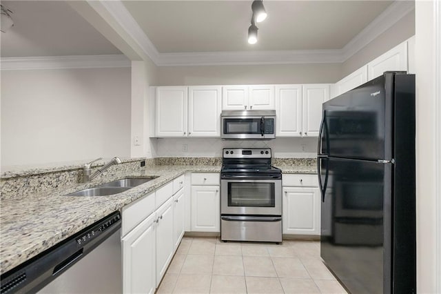 kitchen featuring sink, light tile patterned floors, appliances with stainless steel finishes, white cabinetry, and light stone counters