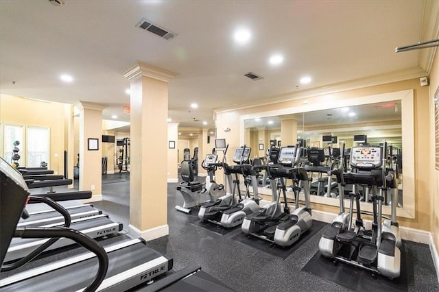 workout area featuring decorative columns and crown molding