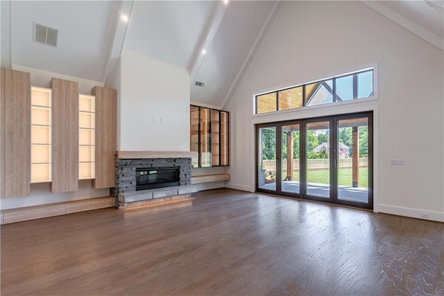 unfurnished living room featuring french doors, dark wood-type flooring, high vaulted ceiling, beamed ceiling, and a fireplace