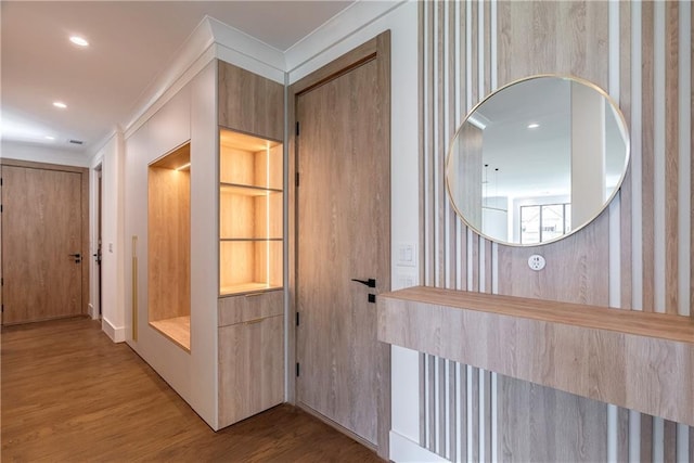 corridor featuring hardwood / wood-style flooring and ornamental molding