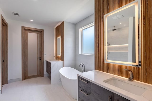 bathroom with vanity and a bathing tub