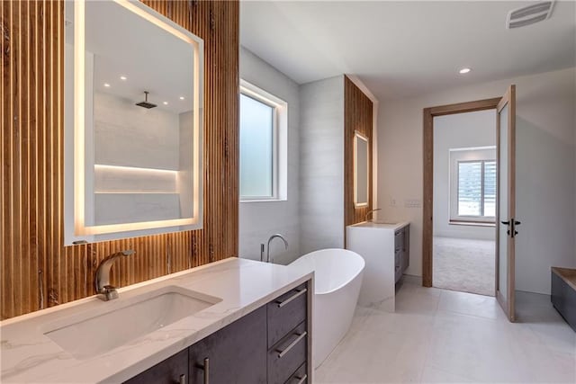 bathroom featuring vanity and a tub