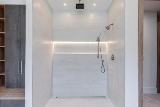 bathroom with tiled shower