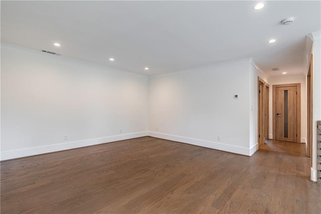 empty room with crown molding and dark hardwood / wood-style floors