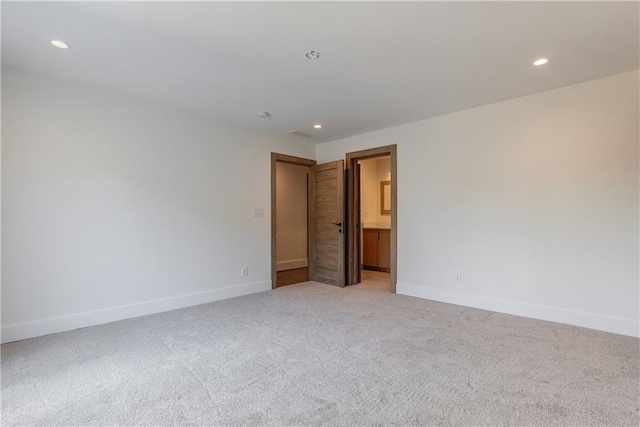 empty room featuring light carpet