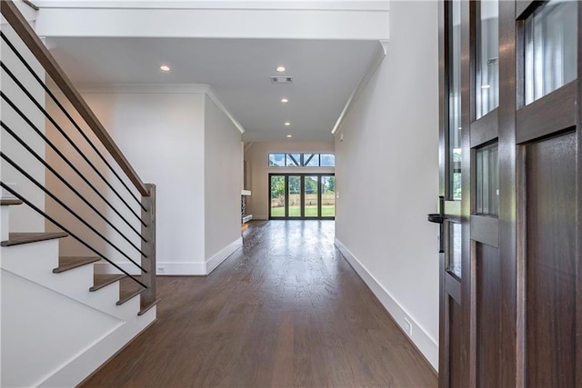 foyer featuring dark hardwood / wood-style floors and ornamental molding