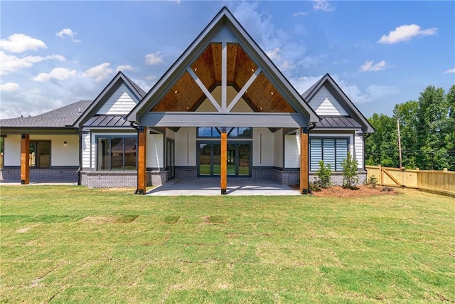 back of property with a patio and a lawn