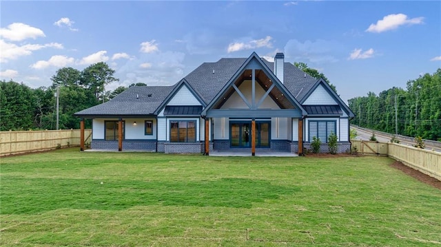 back of property featuring a lawn and a patio