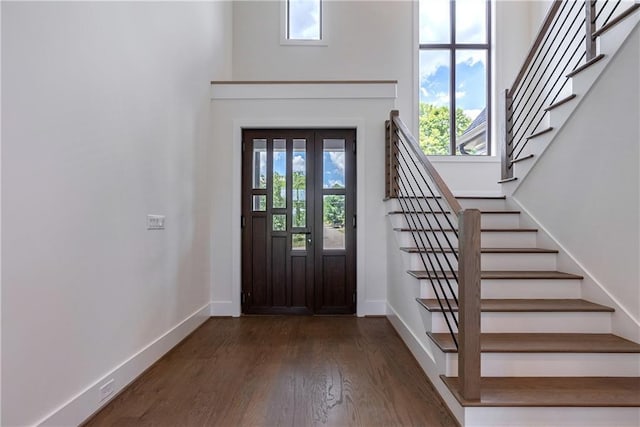 foyer entrance featuring french doors and dark hardwood / wood-style floors