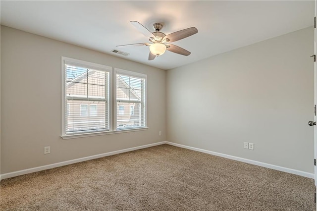 spare room featuring ceiling fan and carpet floors