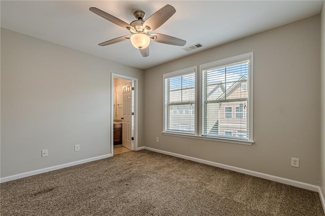 carpeted empty room featuring ceiling fan