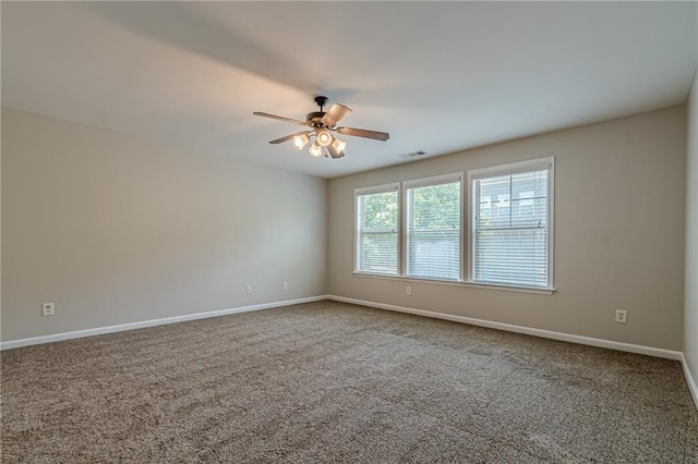 carpeted spare room featuring ceiling fan