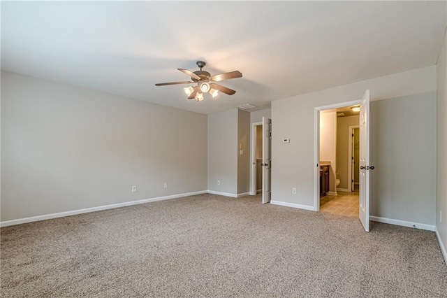 unfurnished bedroom with connected bathroom, ceiling fan, and light carpet