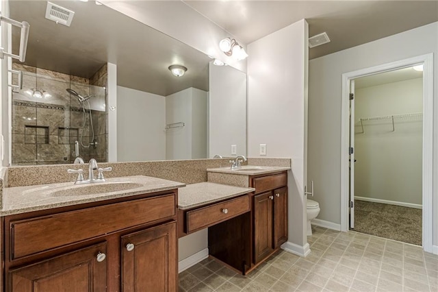 bathroom with vanity, toilet, and a tile shower