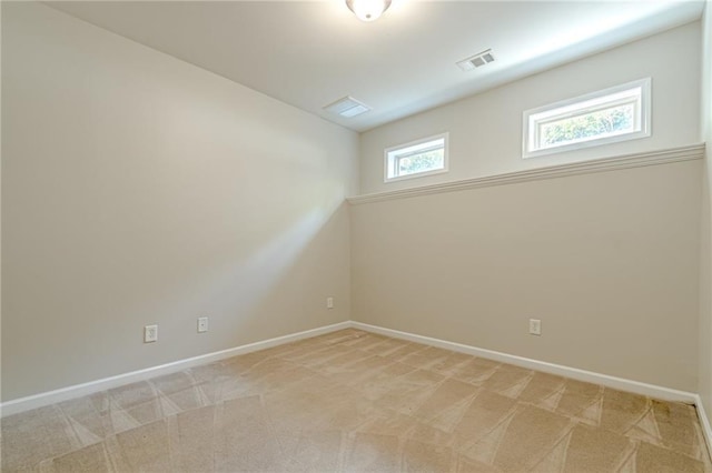 unfurnished room featuring light colored carpet