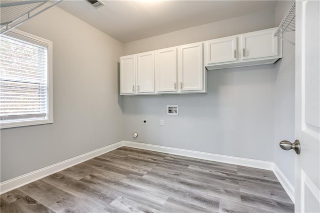 laundry room with cabinets, hookup for a washing machine, electric dryer hookup, and a healthy amount of sunlight