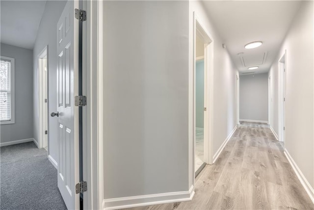 hallway with light hardwood / wood-style flooring