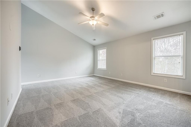 spare room featuring ceiling fan, light colored carpet, and lofted ceiling