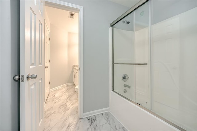 full bathroom featuring shower / bath combination with glass door, vanity, and toilet