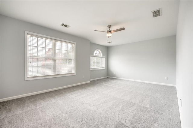 unfurnished room with ceiling fan and light carpet