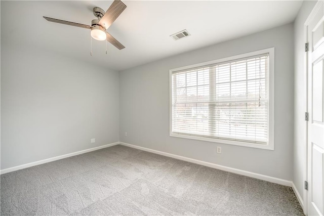 empty room featuring carpet flooring and ceiling fan