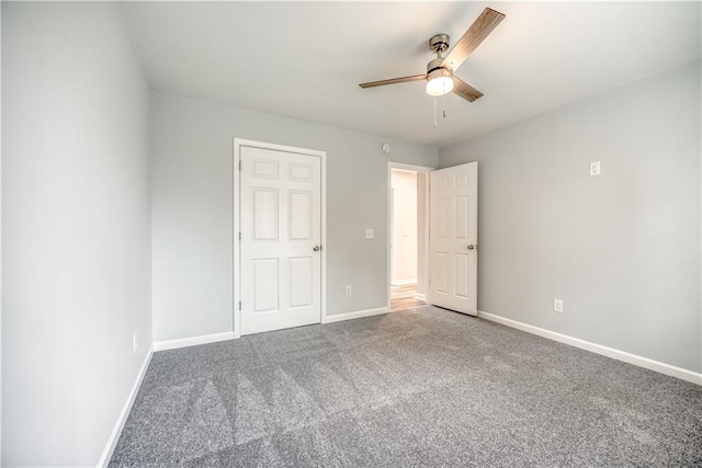 unfurnished bedroom with ceiling fan, carpet floors, and a closet