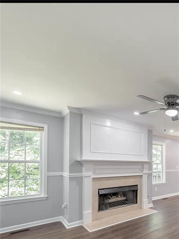 unfurnished living room with crown molding, ceiling fan, and dark hardwood / wood-style flooring