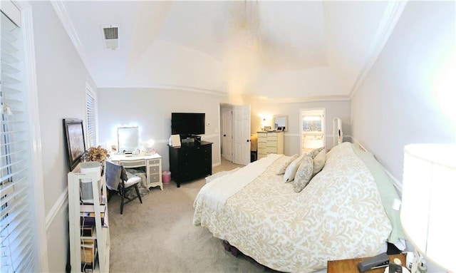 bedroom with ornamental molding and light carpet