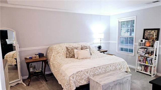 bedroom with ornamental molding and carpet