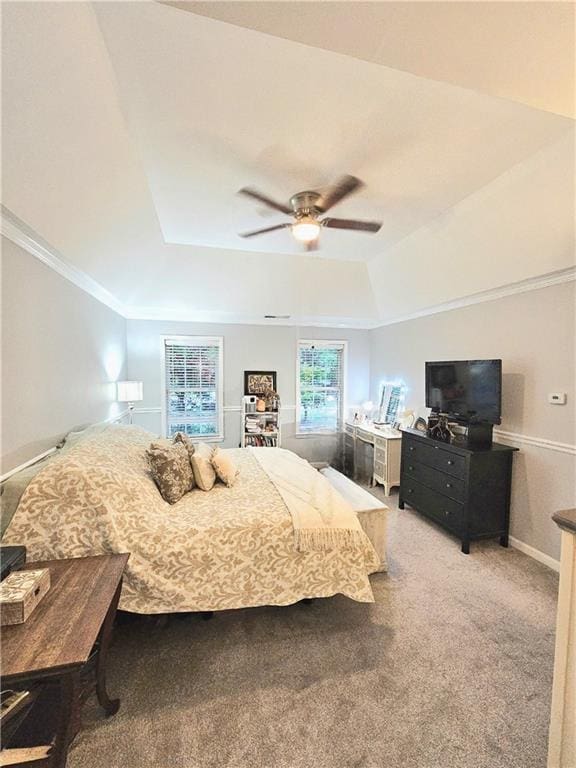 bedroom with crown molding, a raised ceiling, ceiling fan, and carpet flooring