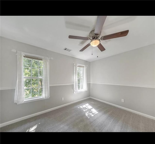 empty room featuring carpet floors and ceiling fan