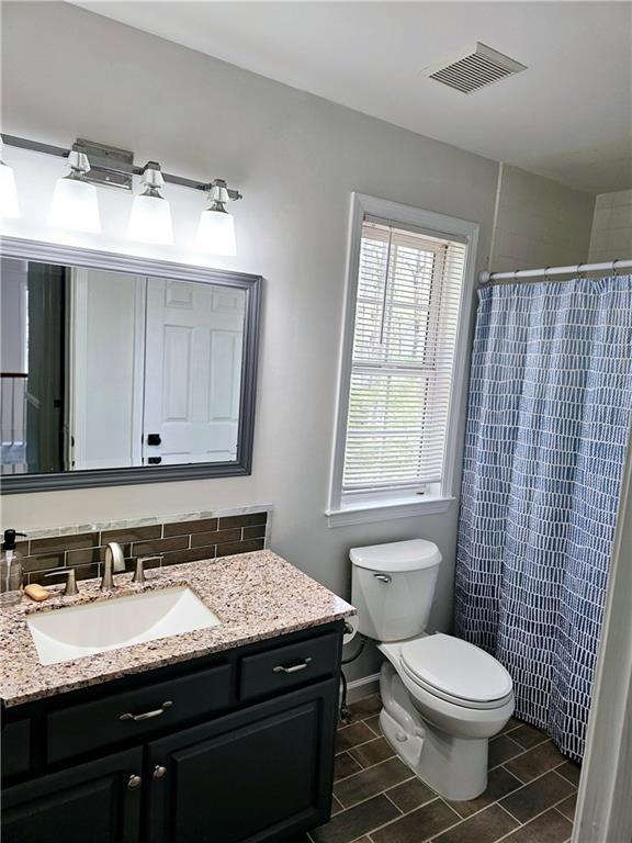 bathroom with vanity, a shower with curtain, and toilet