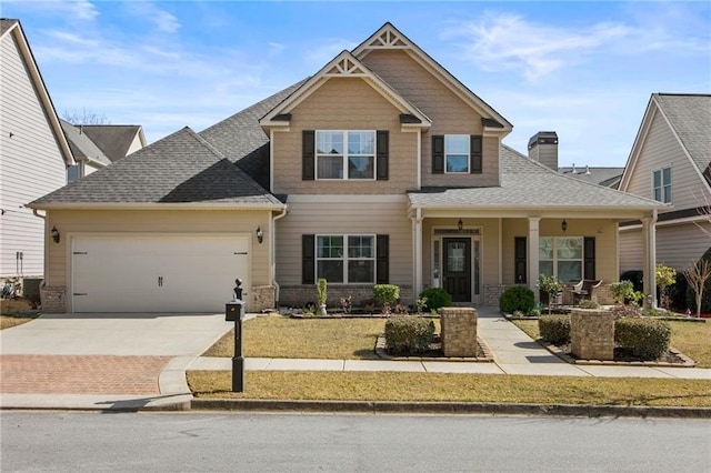 craftsman inspired home with driveway, an attached garage, a shingled roof, a chimney, and brick siding