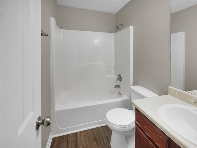 bathroom with shower / bath combination, toilet, wood finished floors, and vanity