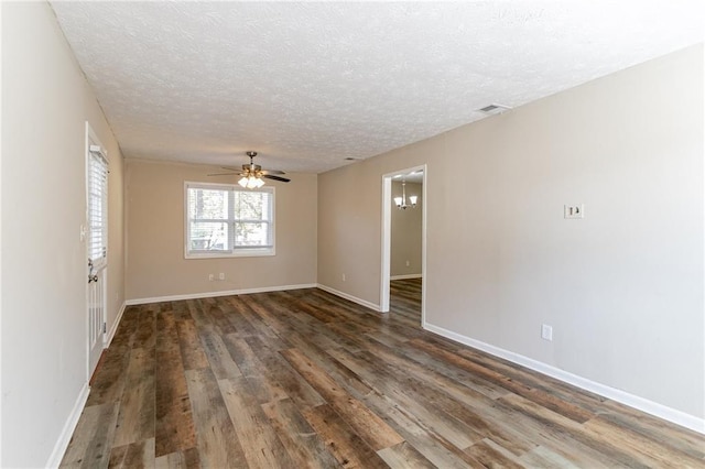 8775 Lee Rd, Lithia Springs, GA 30122 - unfurnished room featuring ceiling fan, dark wood-type flooring, and a textured ceiling