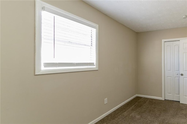 8775 Lee Rd, Lithia Springs, GA 30122 - unfurnished bedroom with carpet flooring, a closet, and a textured ceiling