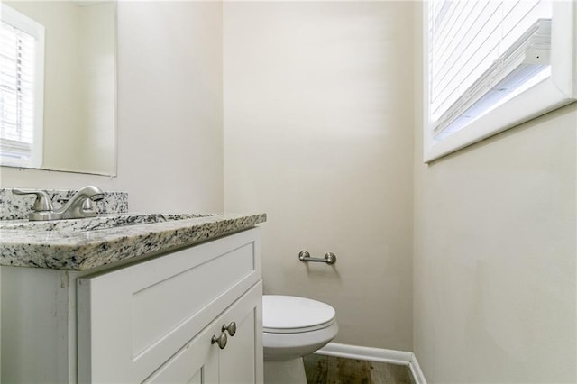 8775 Lee Rd, Lithia Springs, GA 30122 - bathroom featuring hardwood / wood-style floors, vanity, and toilet