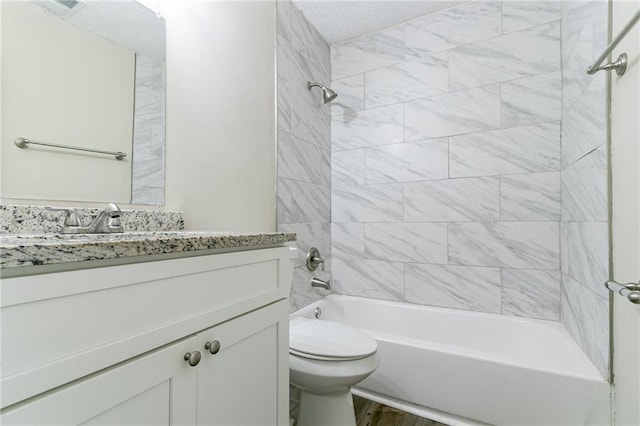 8775 Lee Rd, Lithia Springs, GA 30122 - full bathroom featuring vanity, tiled shower / bath combo, hardwood / wood-style flooring, and toilet